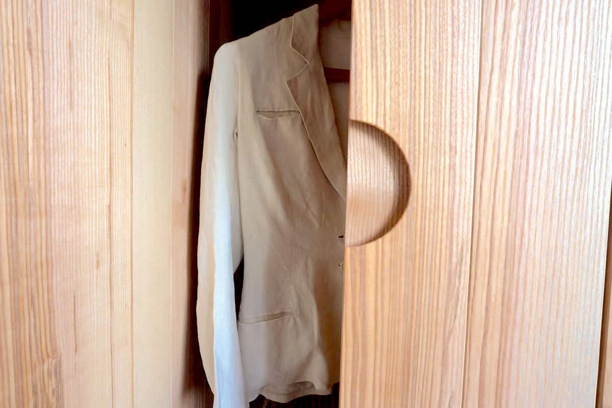 a white jacket inside a bespoke ash wardrobe