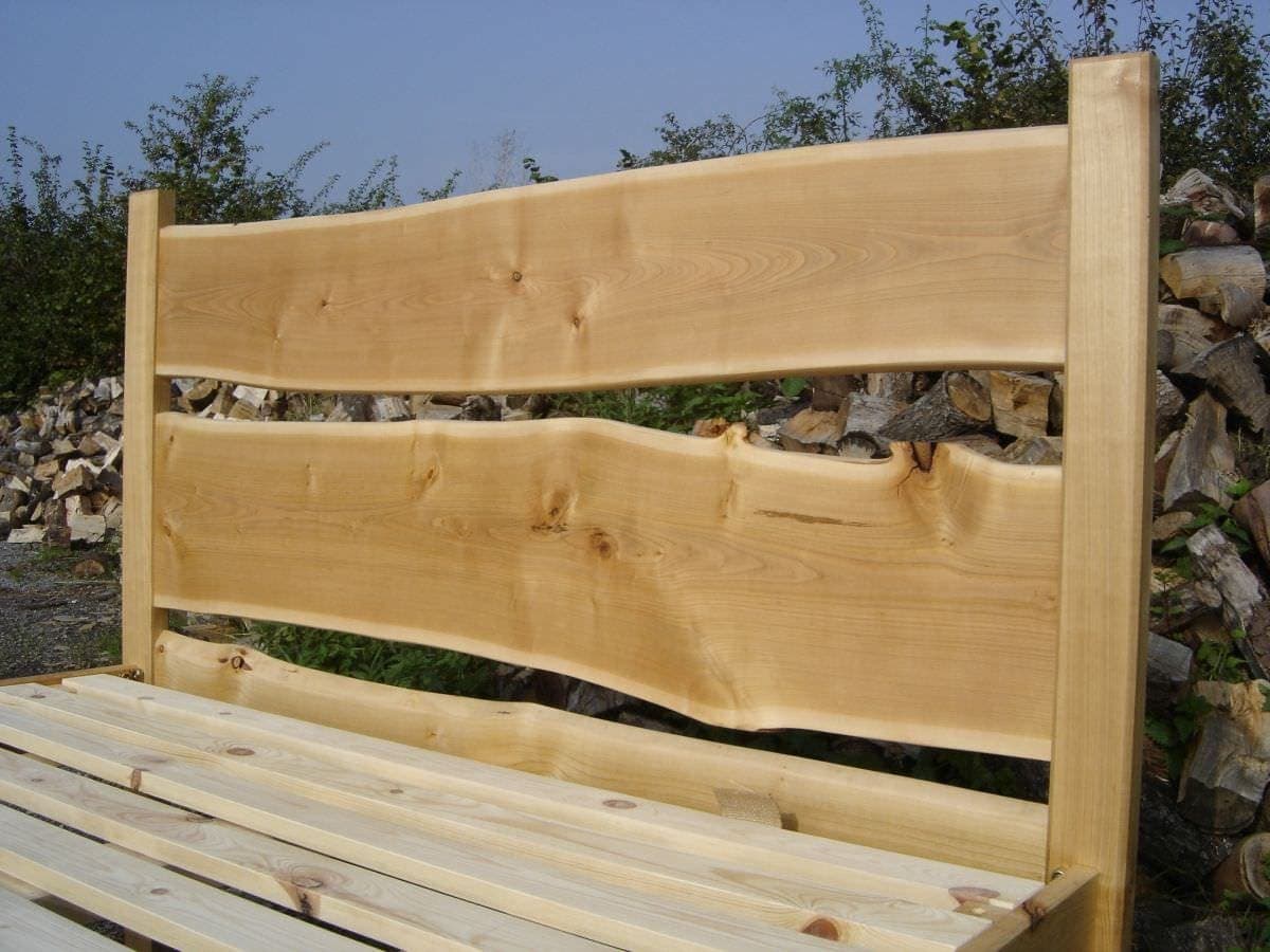 a wooden bench with a stack of wood