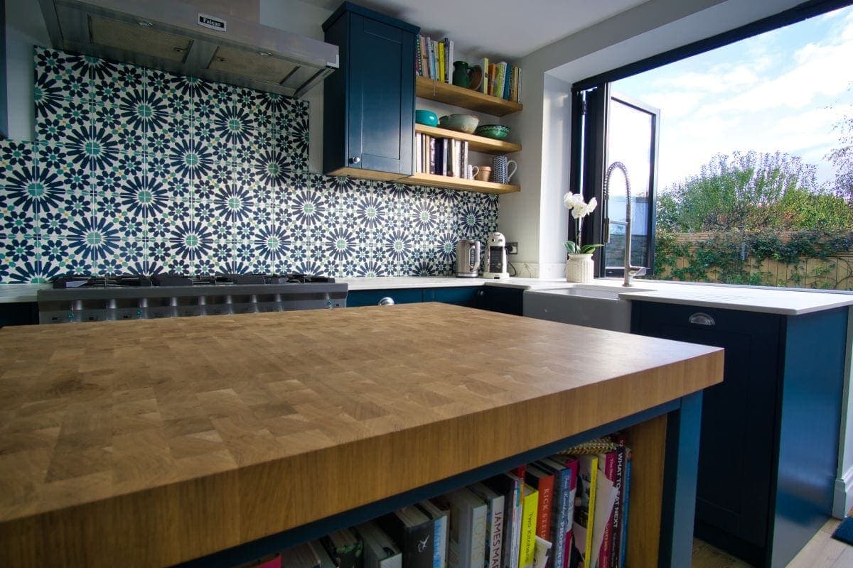 a kitchen with a wood countertop and shelves