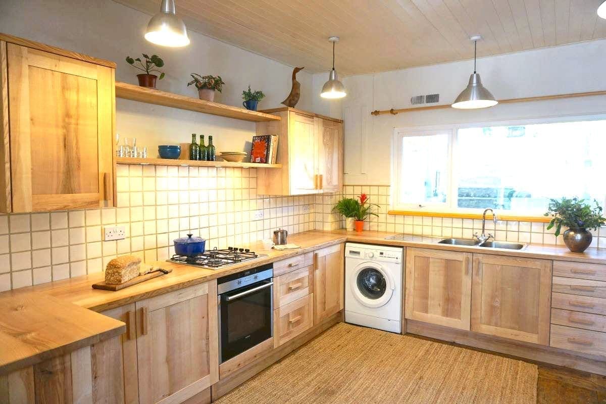 a handmade ash kitchen with wood cabinets and appliances