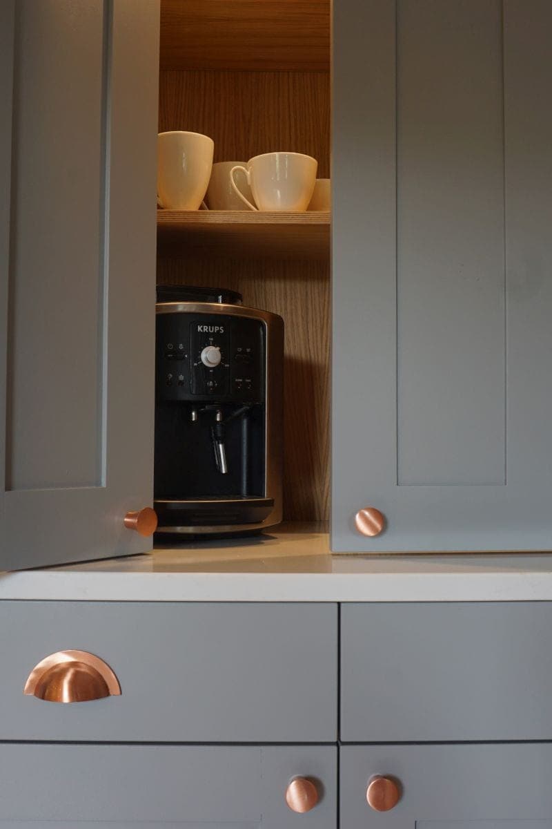 a coffee maker in a cabinet