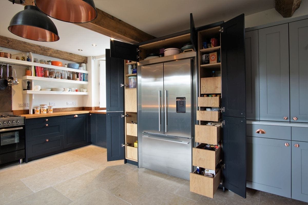 Custom cabinets surrounding a Fisher and Paykel fridge, seamlessly integrated into the shaker kitchen design.