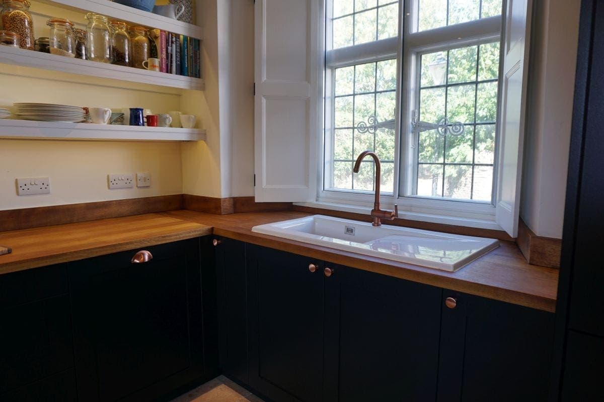a kitchen with a sink and shelves