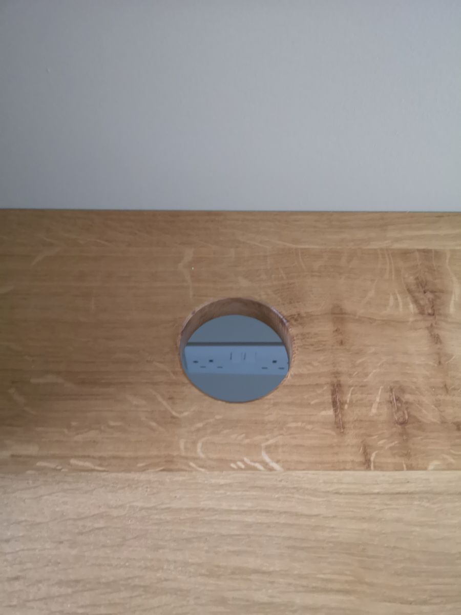 Cable management hole in bespoke desk