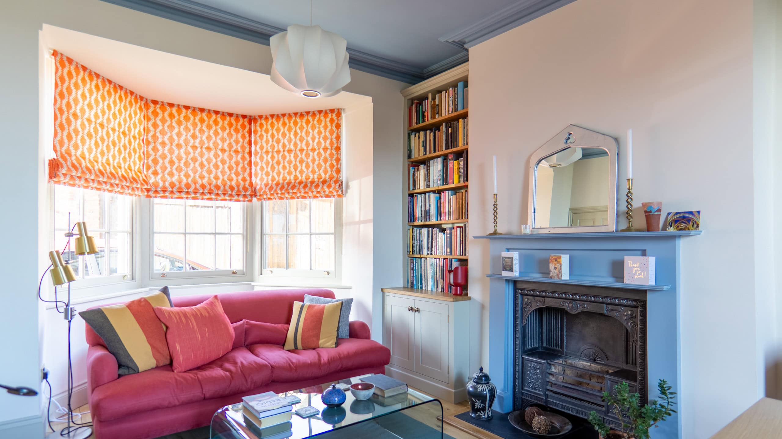 Traditional alcove bookcase and cabinet built to fit seamlessly into a period home, with carefully designed storage for books and personal items. Features an elegant painted finish and solid oak details.
