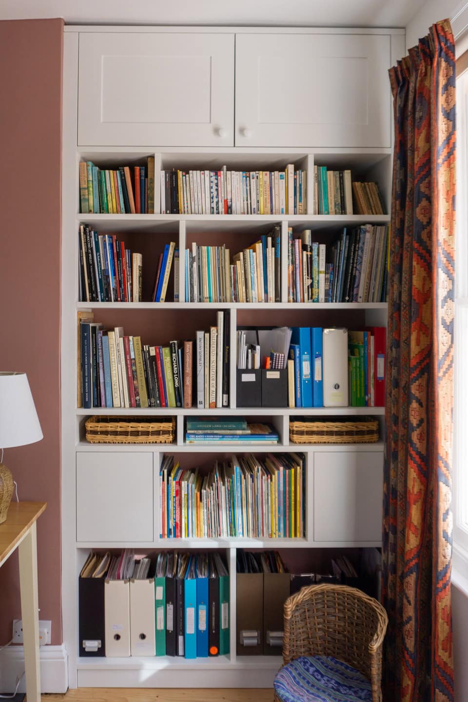 a white bookcase with books on it