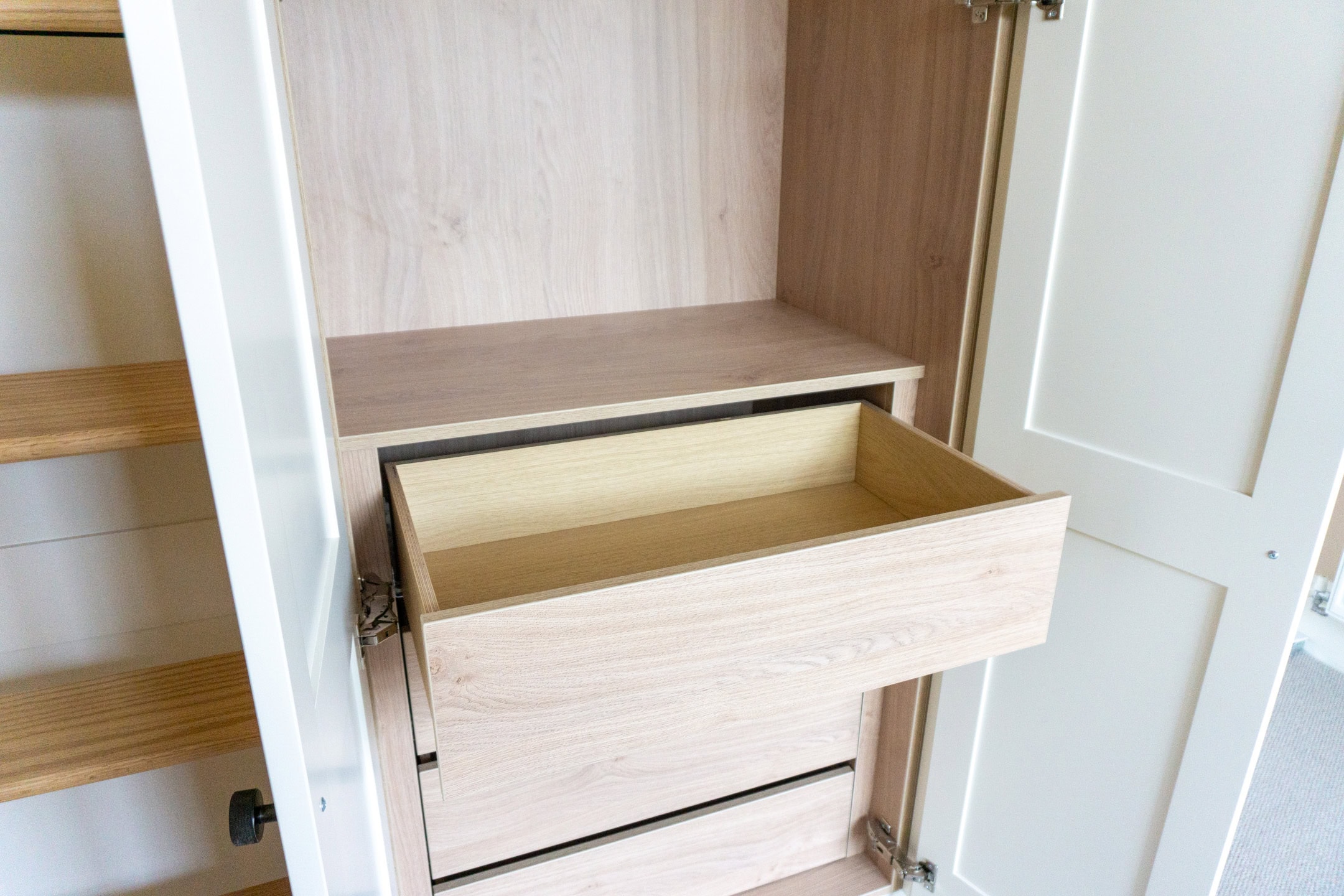 a oak plywood set of drawers in a white shaker wardrobe