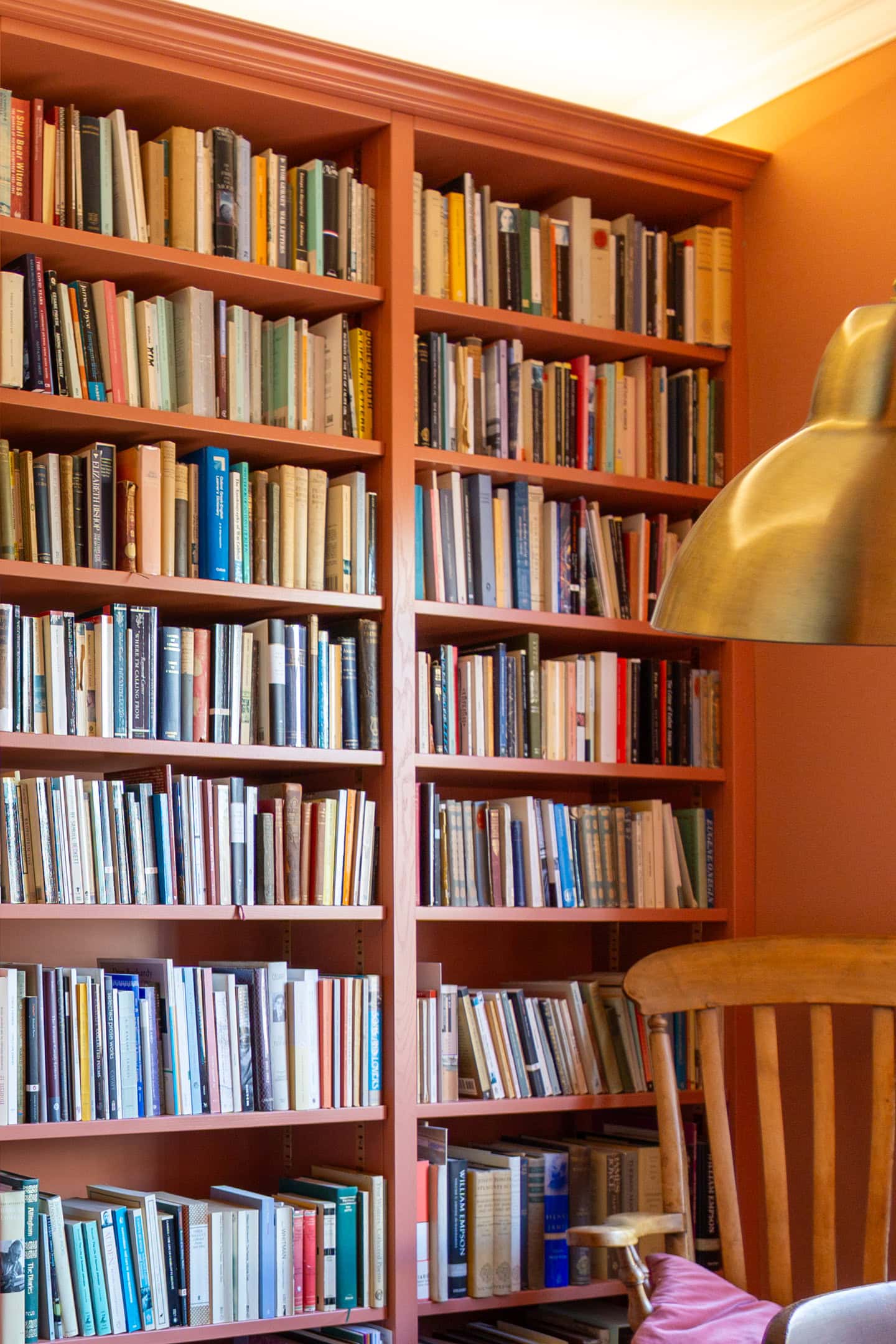 corner shot of red bespoke bookcase library Bristol with fitted lights