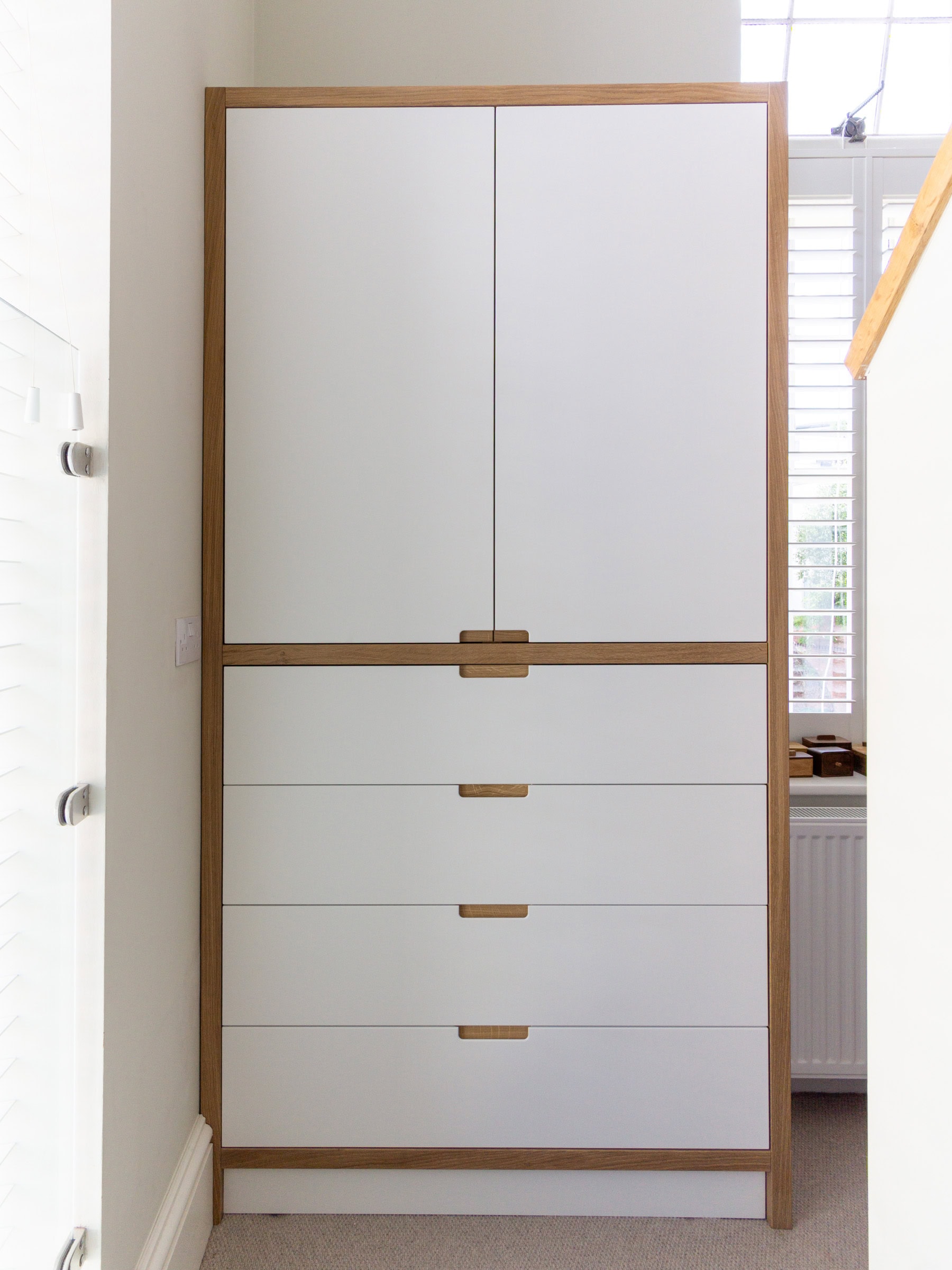 a white and wood modern built-in wardrobe Bristol