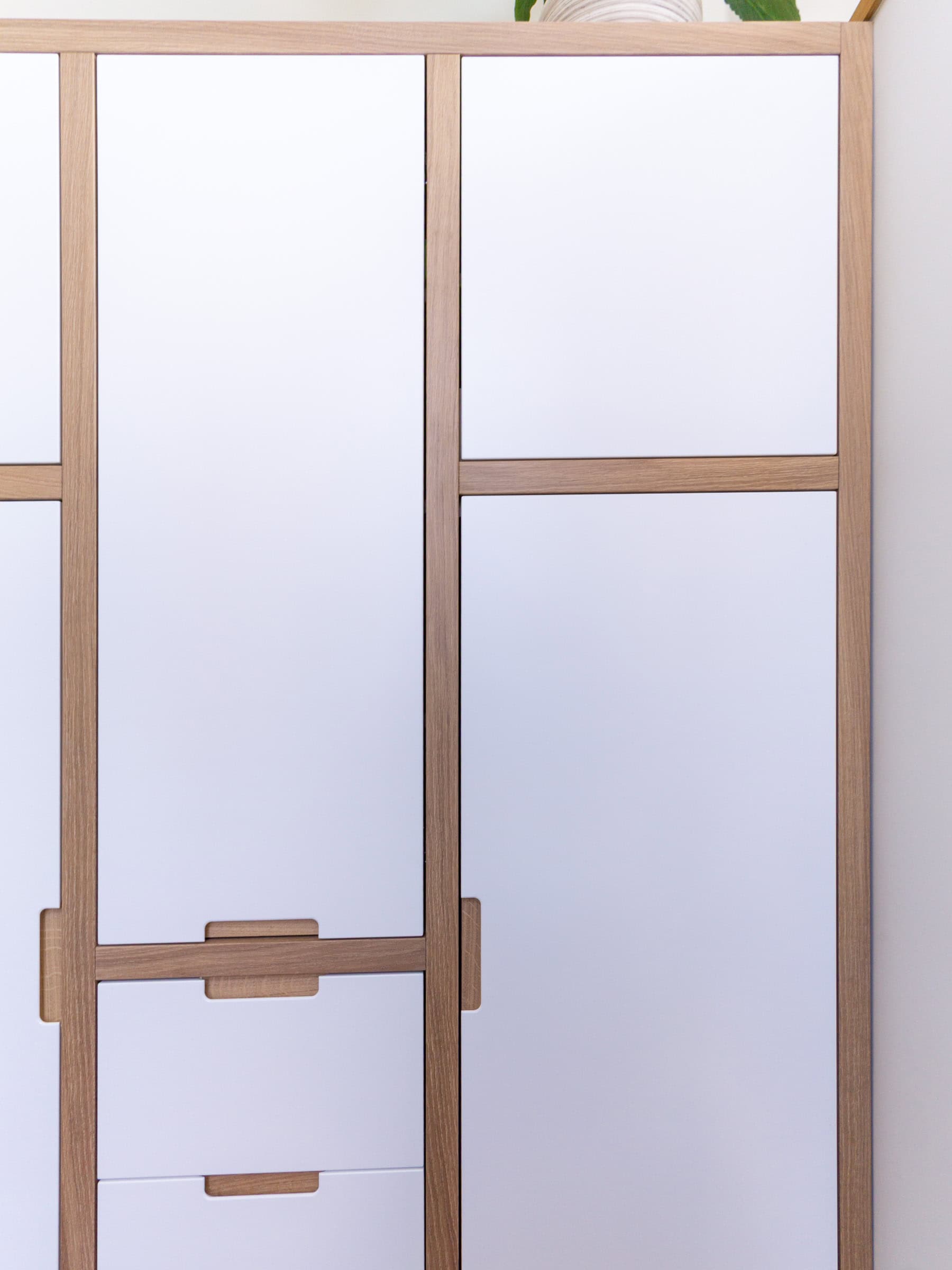 close up of an oak framed modern built-in wardrobe Bristol