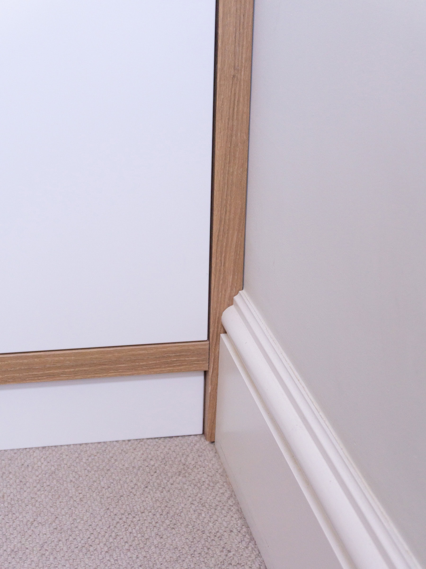 Oak wardrobe showing how the skirting is cut in to fit - a neat clean installation