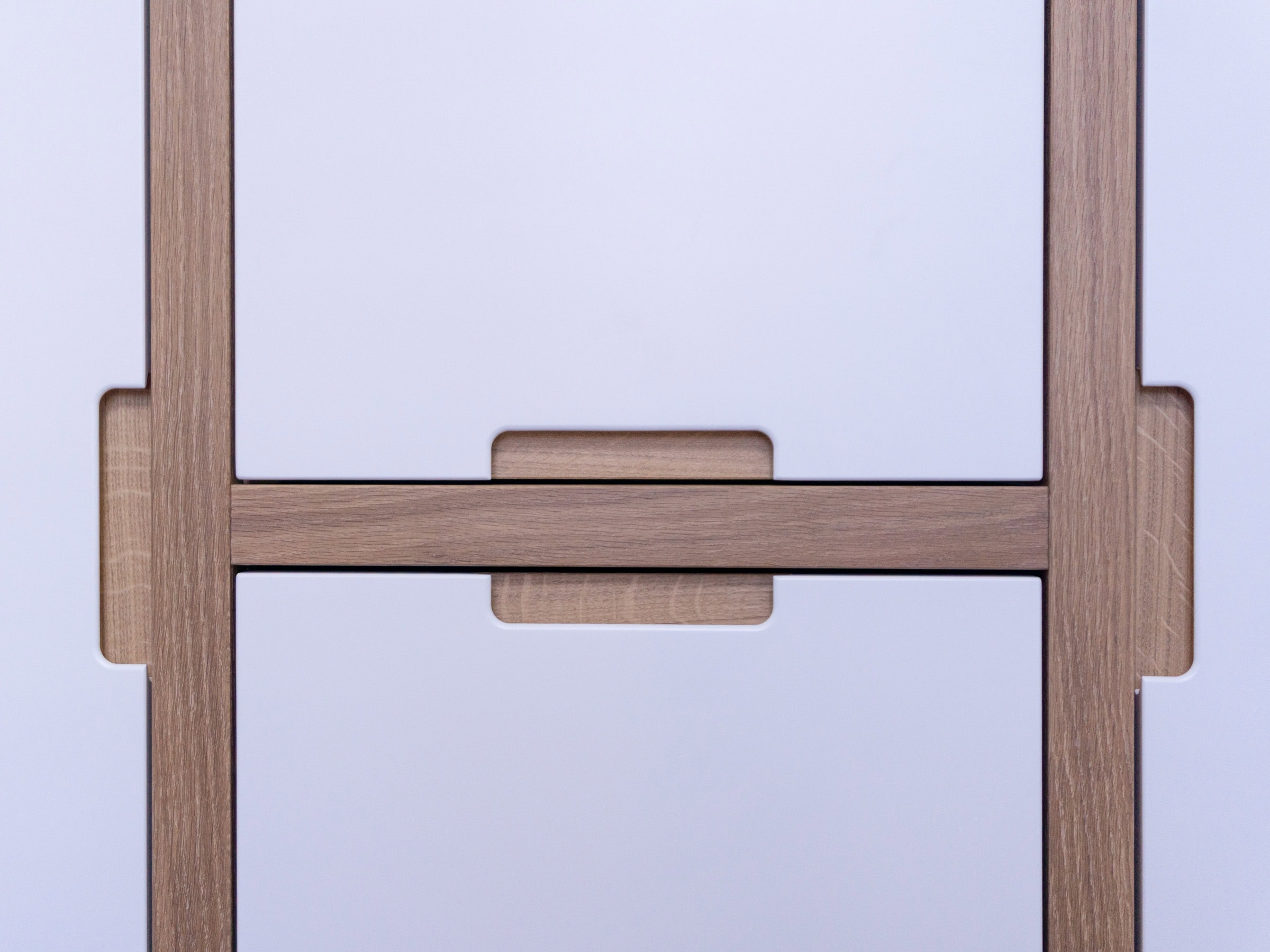 cutout handle details in oak on a white modern wardrobe