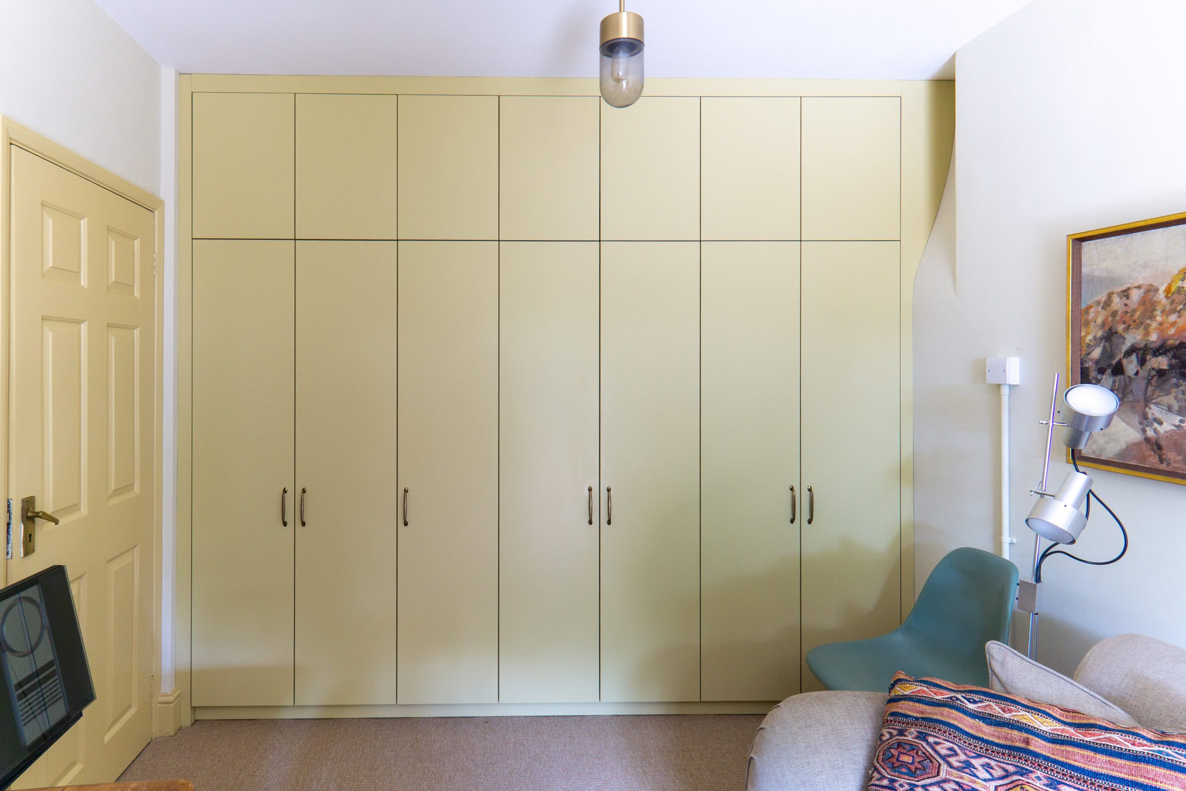 run of yellow wardrobes with a secret door through to a cellar