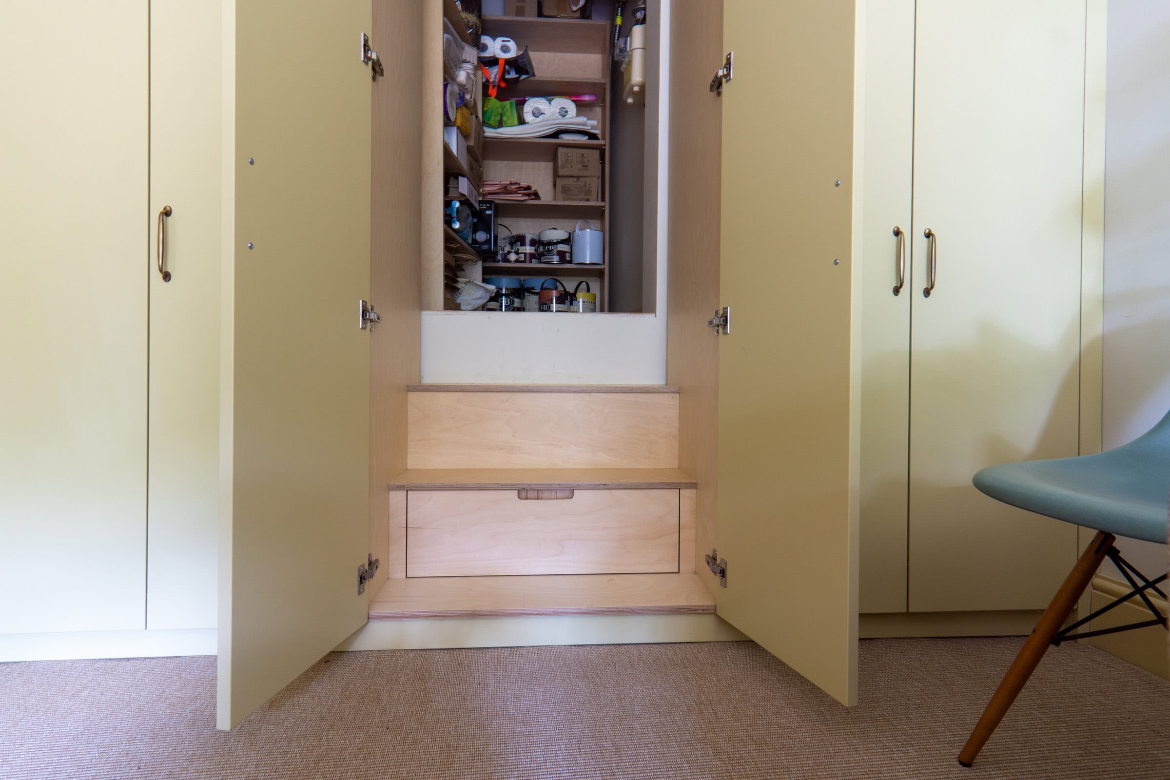 a closet with a hidden steps and shelves