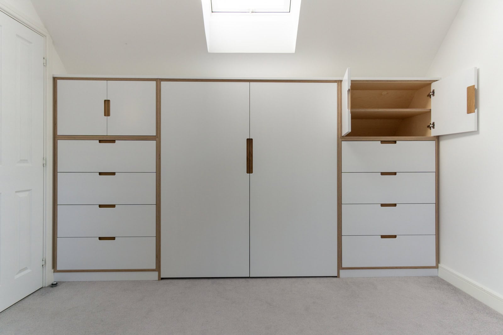 Loft wardrobe with access to storage in the eaves behind hanging space